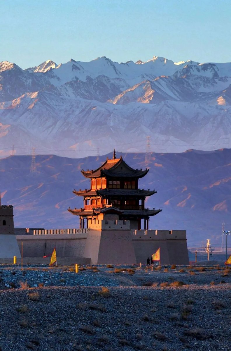 Jiayuguan Fort at sunset with snow-capped mountains, a key highlight of the Epic 8-Day Silk Road Adventure in China.