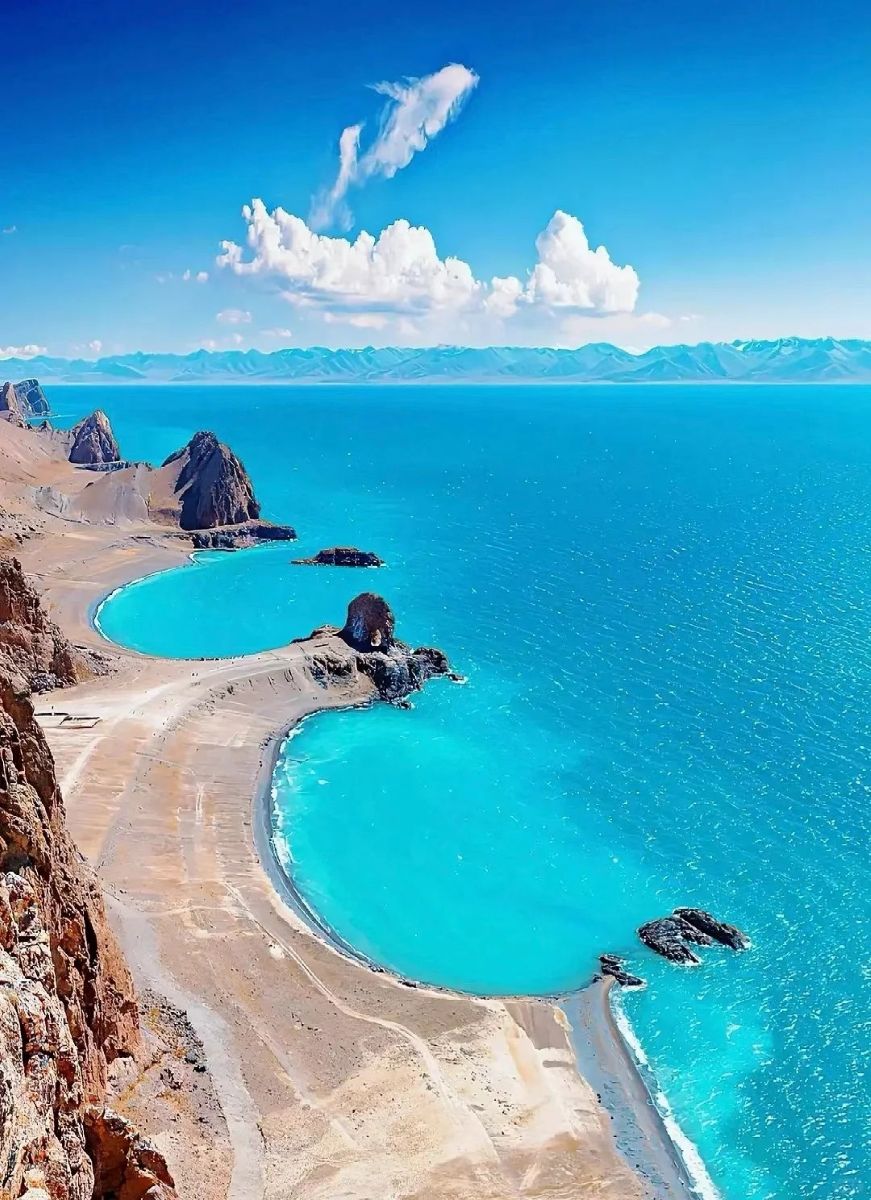 Breathtaking view of turquoise lakes and rocky coastline in Qinghai, China, showcasing stunning natural beauty.