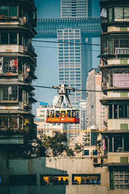 Chongqing skyline with a cable car traveling between buildings, showcasing the city’s unique architecture and urban landscape.